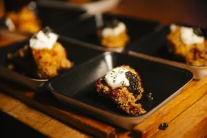 Small bites topped with caviar served on slate
