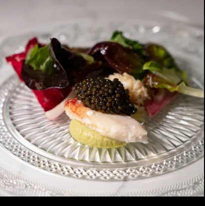 Caviar, lobster and beets on cut crystal
