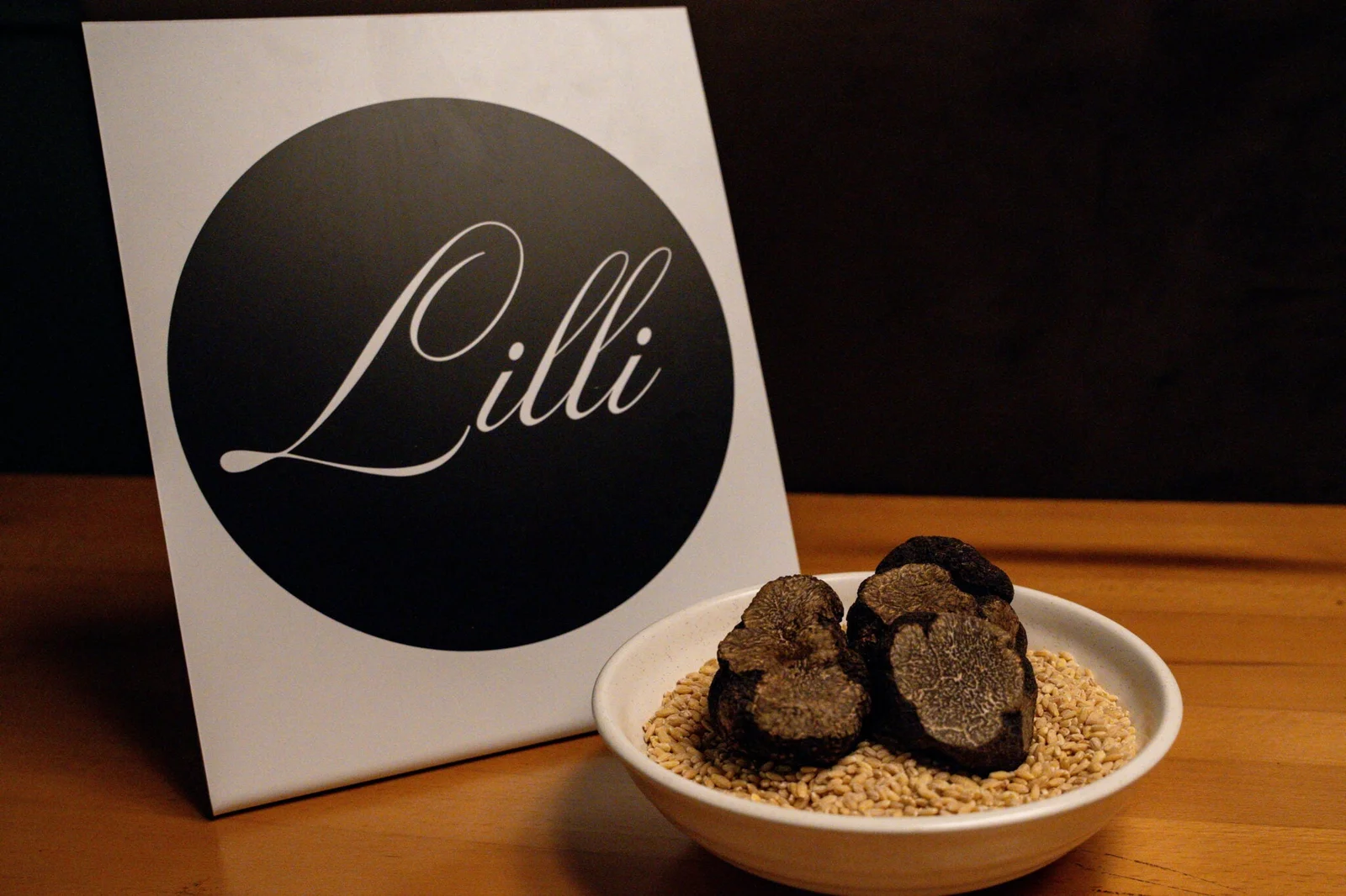 Black truffles beside a Lilli logo sign
