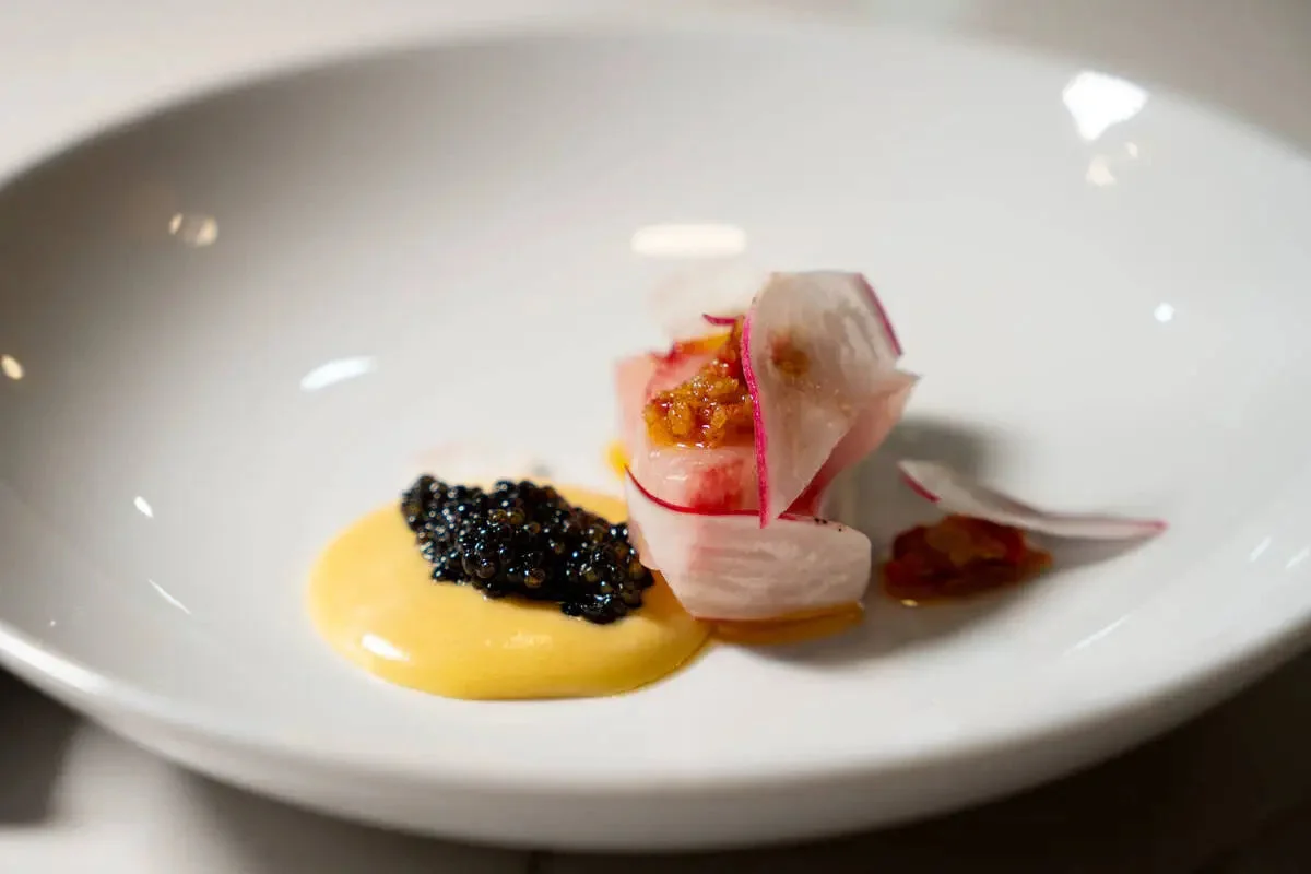 Hawaiian kanpachi with caviar in a white bowl