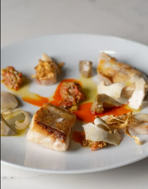 Seared fish with artichoke and pepper sauce